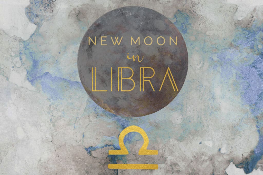 The words New Moon in Libra are written in gold over a dark circle and above a golden astrological symbol of Libra. The background of the image is a blue and gray abstract watercolor.